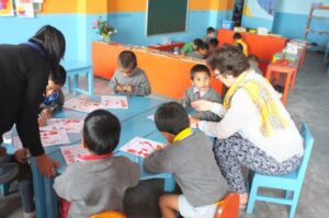 Volunteers teaching children in the Himalayas